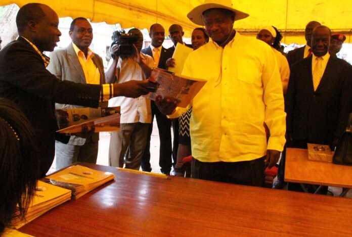 NRM EC chairman Dr Tanga Odoi hands over forms to Museveni at a previous nomination exercise.