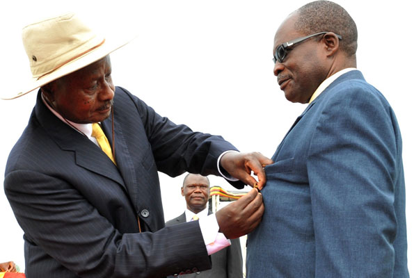 President Museveni decorates then Security Minister Muruli-Mukasa with the Nalubale Medal during the Heroes day in 2012.