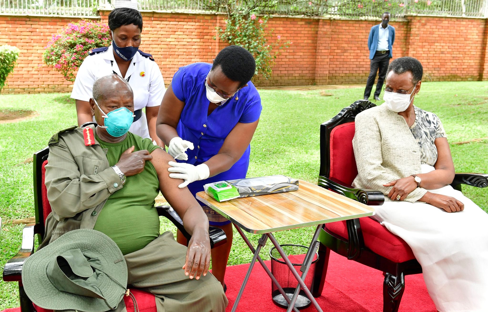President Yoweri Museveni takes his Covid19 AstraZeneca vaccine jab as first lady Janet Museveni waits for hers.