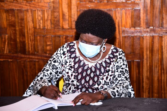 Kadaga signing Jacob Oulanyah condolence book