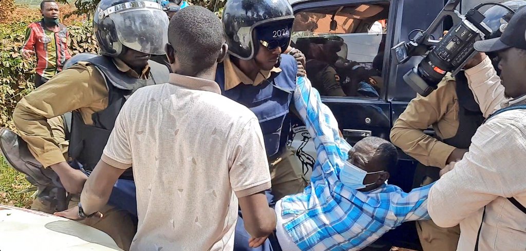 Besigye being arrested by Police officers.